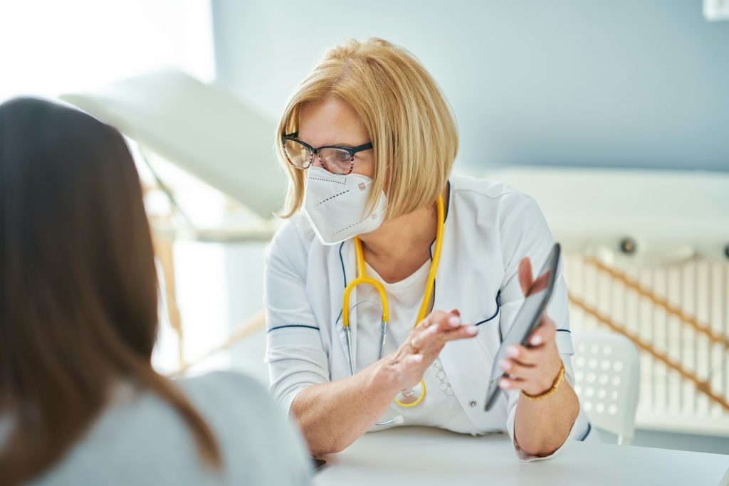 Pediatrician doctor examining little kids in clinic