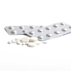 Various health pills, antibiotics, vitamins, scattered tablets, blisters.