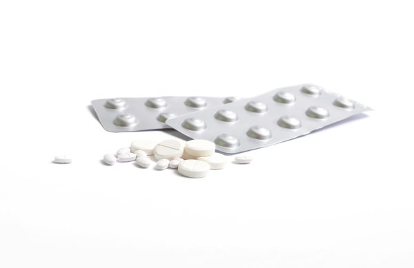 Various health pills, antibiotics, vitamins, scattered tablets, blisters.